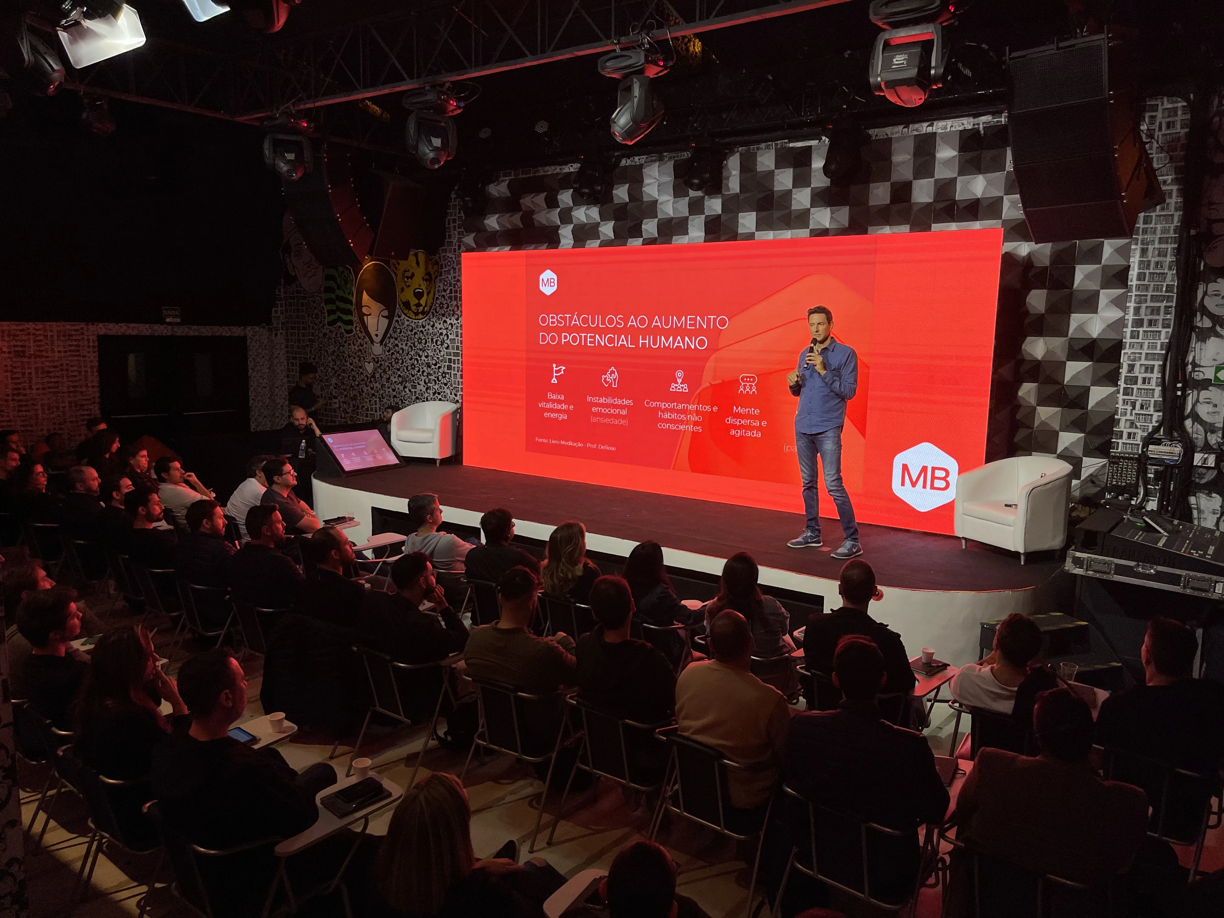 William Câmara no palco durante palestra